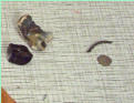 Right side: fragment of Roman-British 2-strand copper alloy bracelet; Nummus coin ofValentinian I (364-375AD)